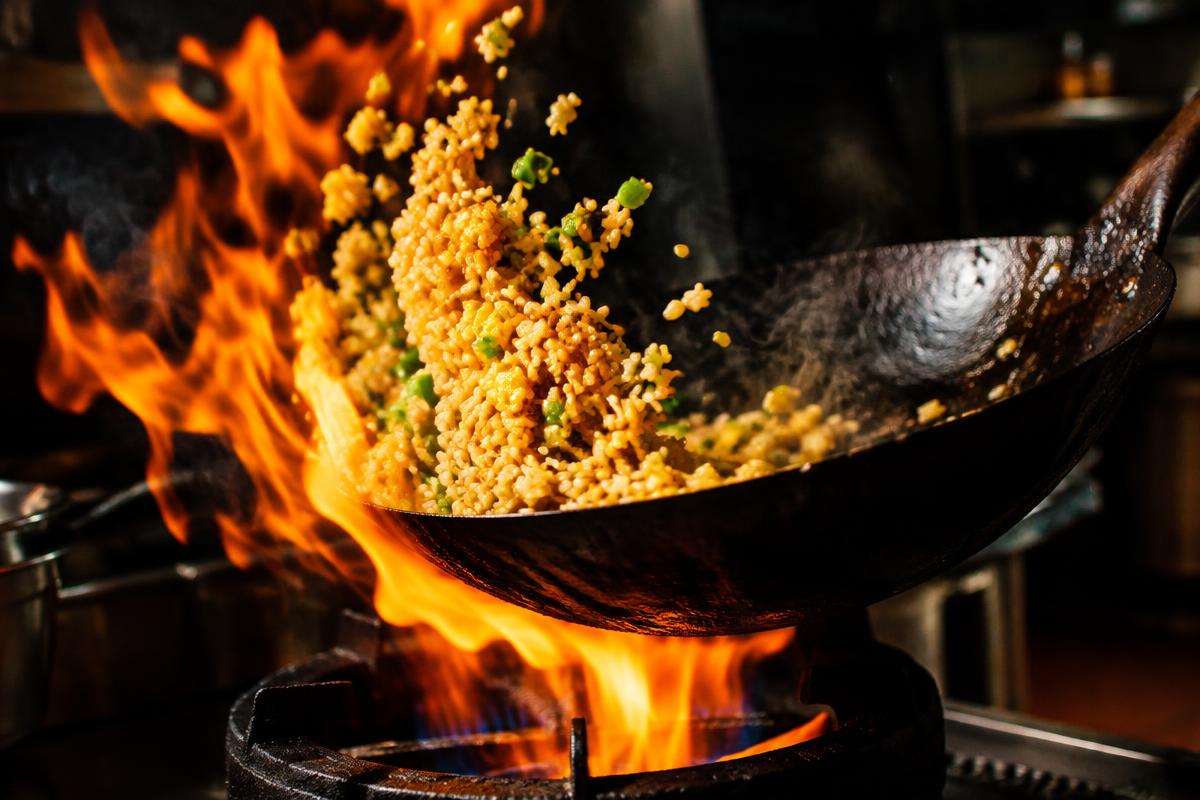 Egg fried rice tossed in a flaming wok